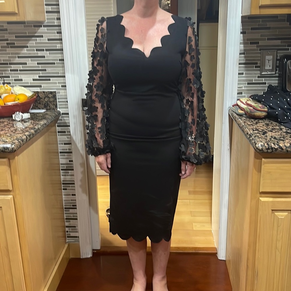 Black cocktail dress with flower arms